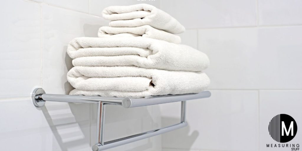 folded bath towels on a rack 