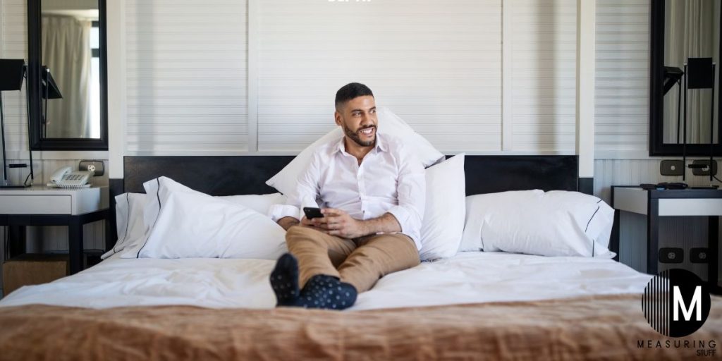 man sitting on hotel bed