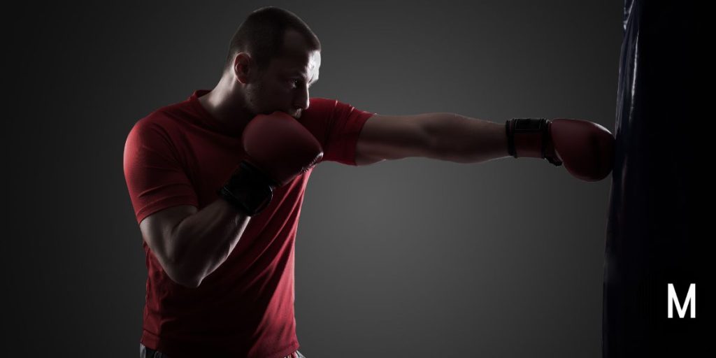 man punching a punching bag