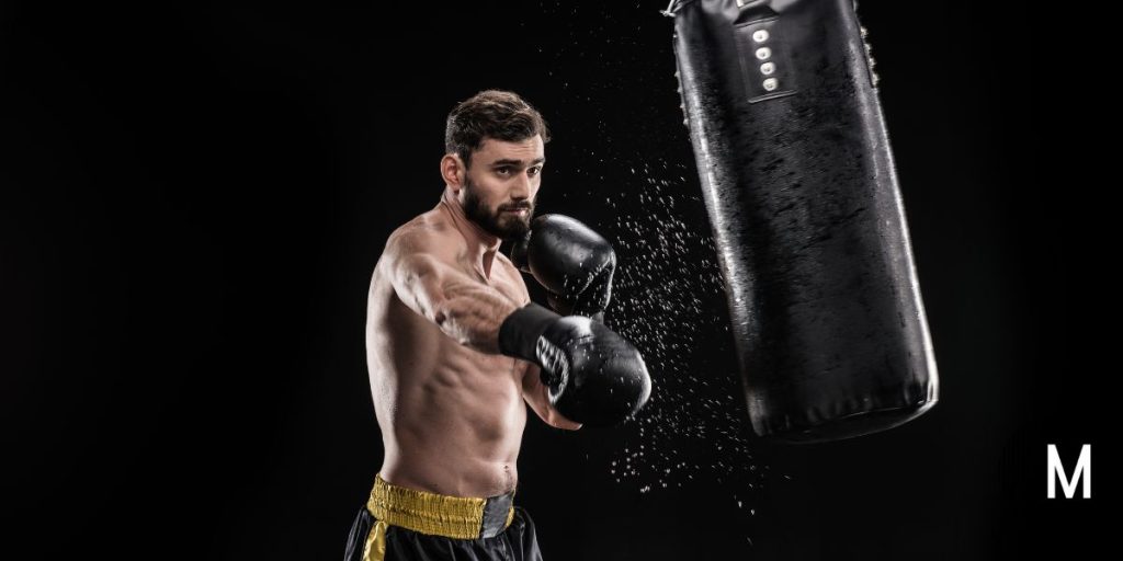 man punching a punching bag