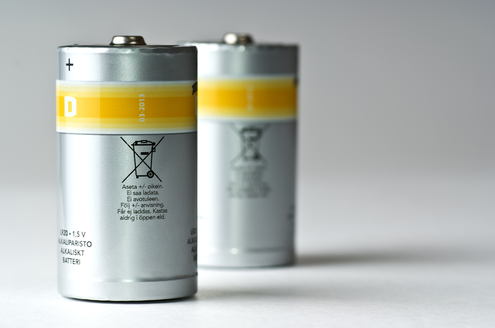 two standing D batteries, silvery with yellow strip
