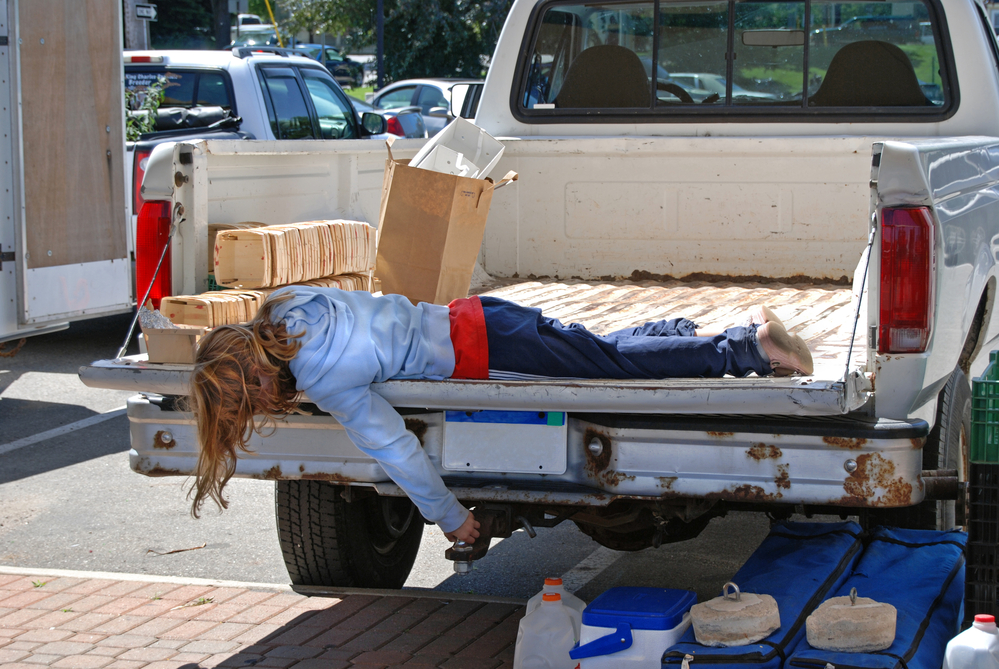 girl laying on truck tailgate 