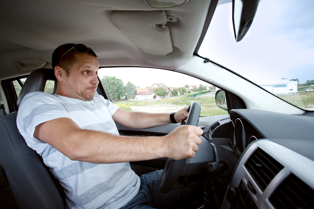 Scared man driving car very fast,  focused on the driver's face