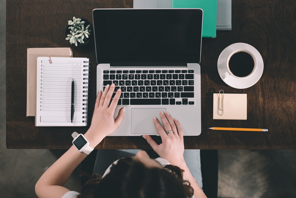 woman using a laptop on a desk