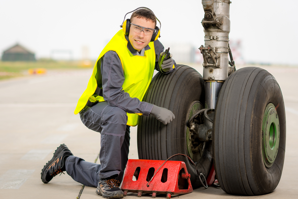 airport worker mechanic service maintenance chassis tire