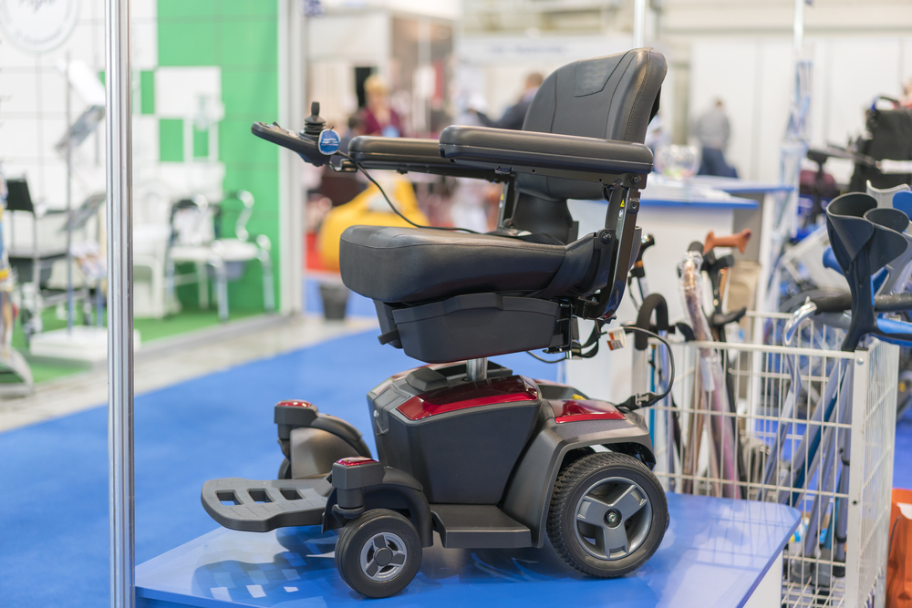 Wheelchair at a medical exhibition. Wheelchair with electric motor