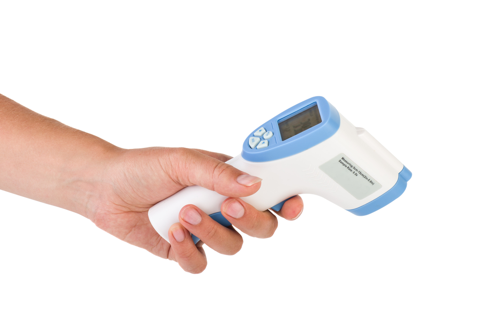 Hand hold a non-contact IR body thermometer isolated on white background