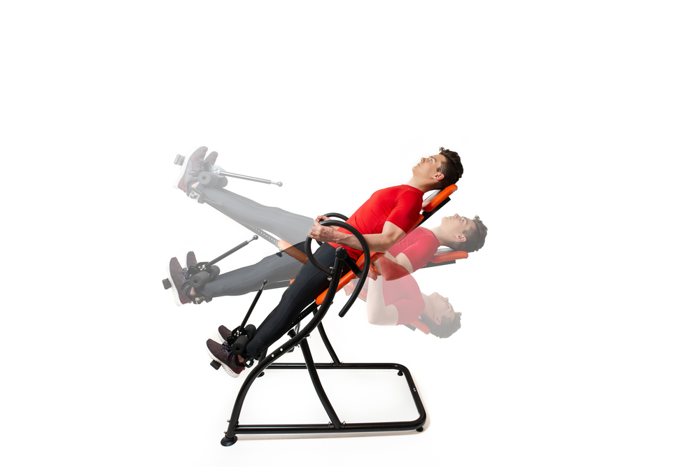 man doing exercises on inversion table