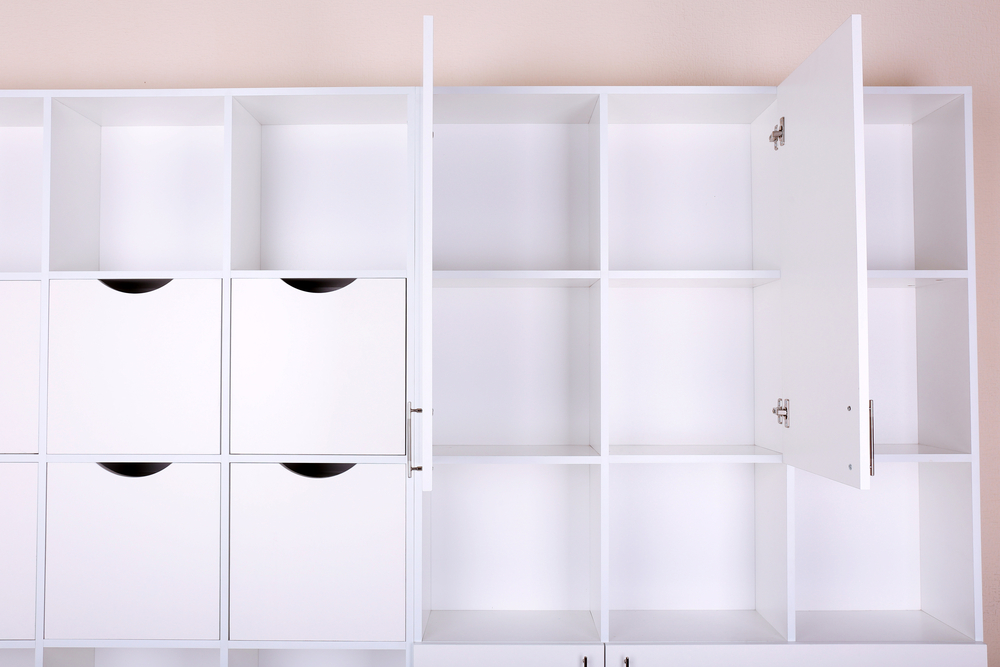 Empty white shelves close up with storage cubes