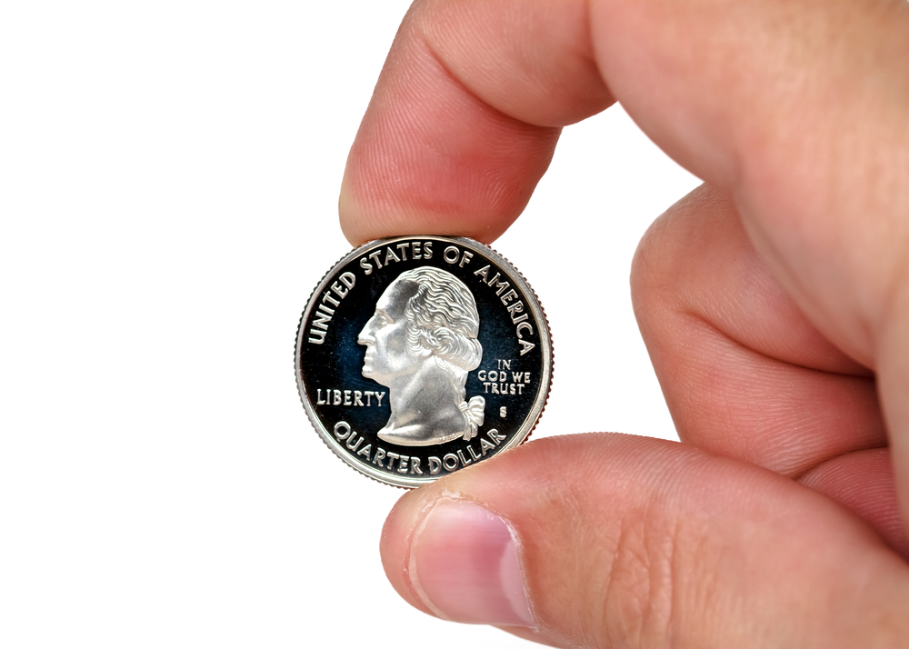 holding a quarter coin between fingers