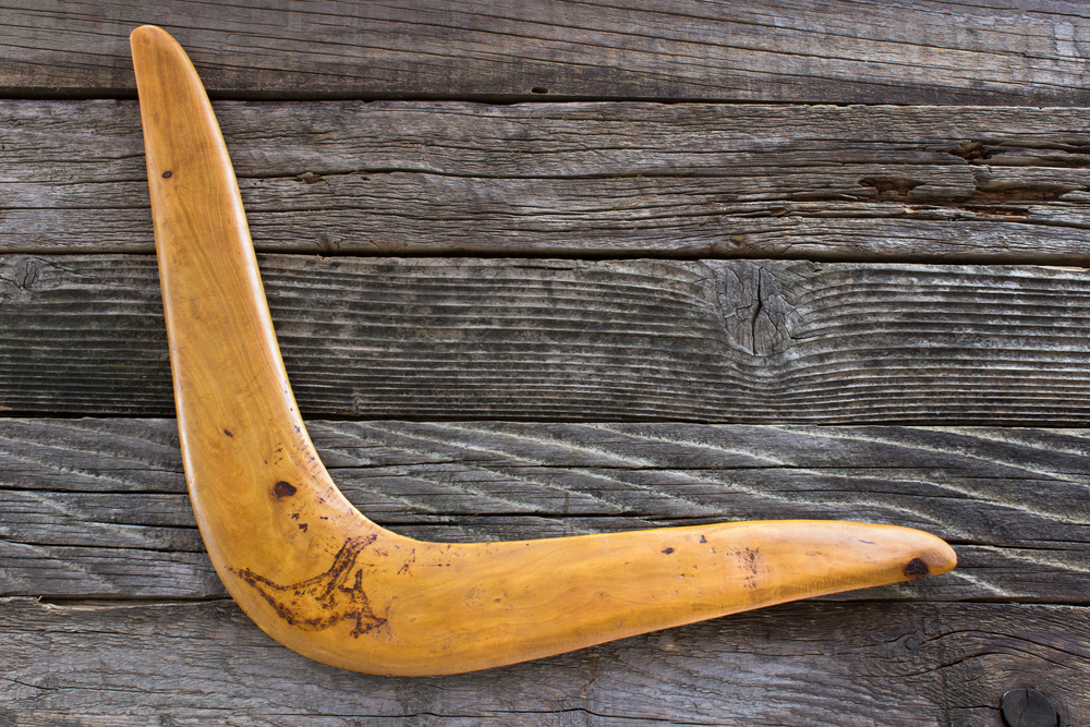 Boomerang on old wooden board