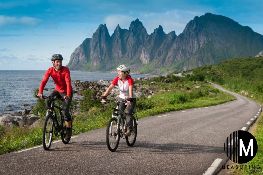 couple riding bikes on pavement
