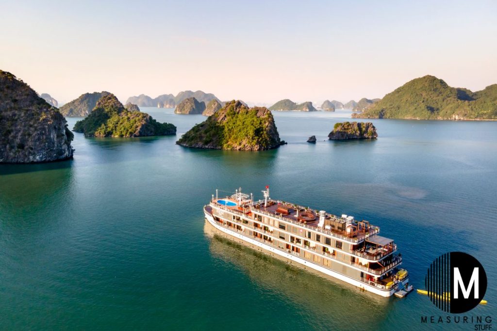 large cruise ship moving towards islands