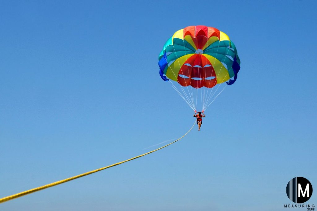single person parasailing blue sky