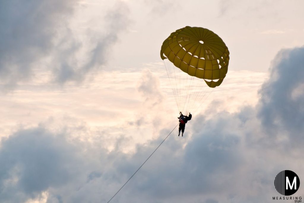 single person parasailing on a cloudy day