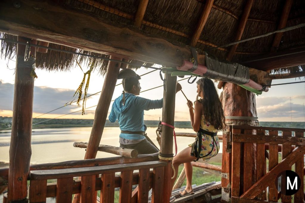 woman on zip lining platform with instructor
