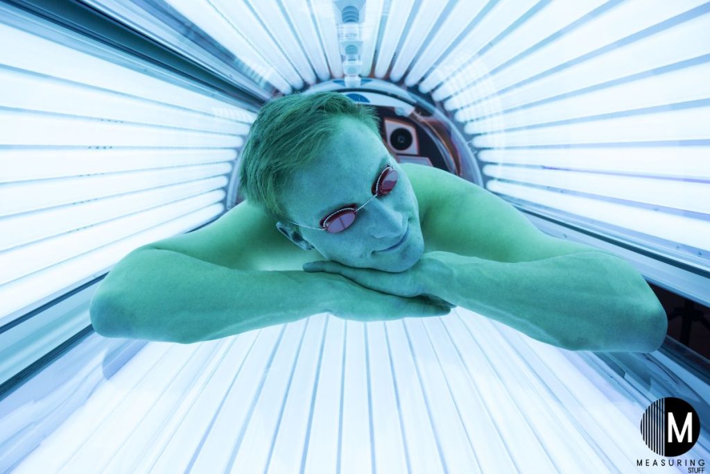 man laying in a tanning bed
