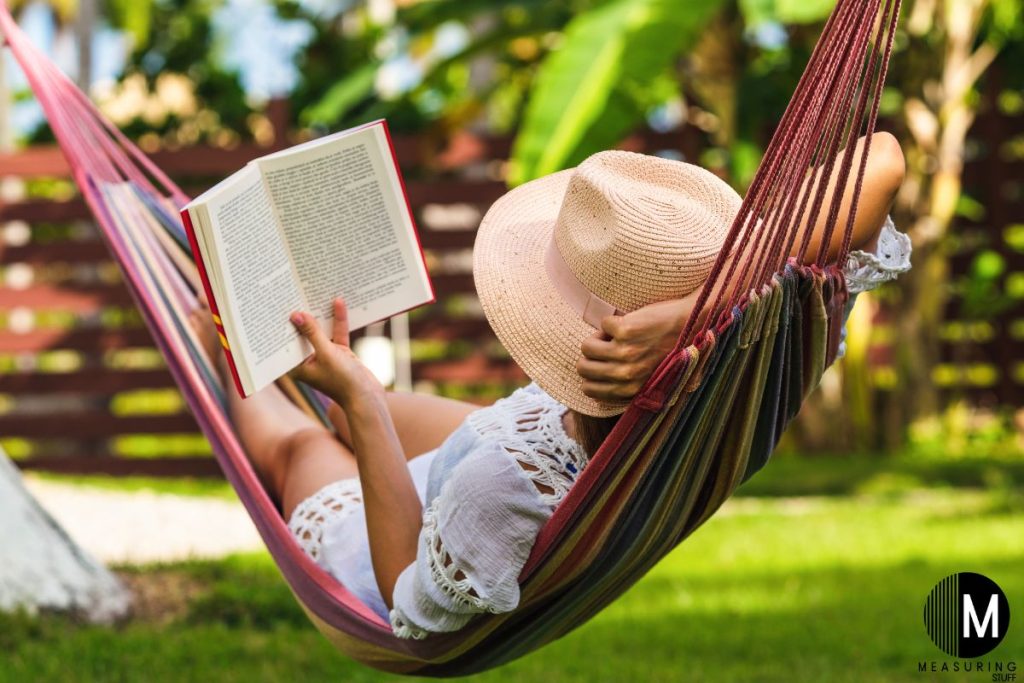 woman reading a book in a hammock