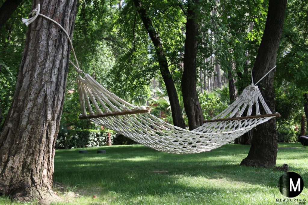 a hammock tied to trees with a rope