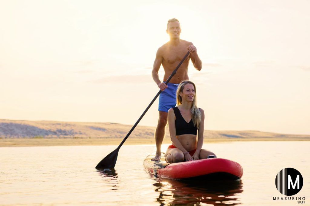man and woman on a paddle board