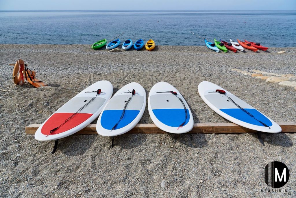 paddle boards laying on the beach