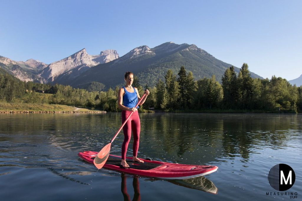 woman on a paddle board with mountain in the background