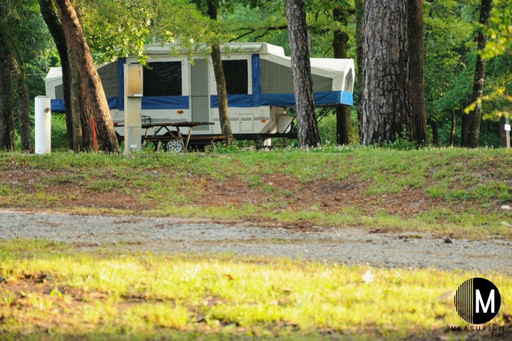 set up pop up camper on a camping lot