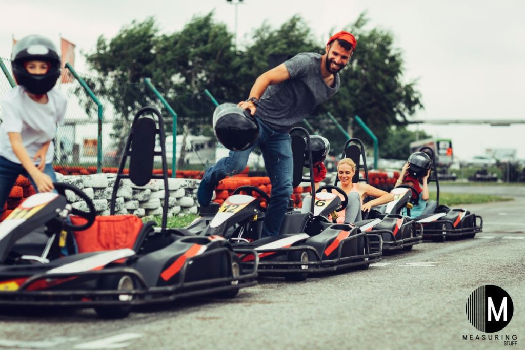 tall man exiting a go kart
