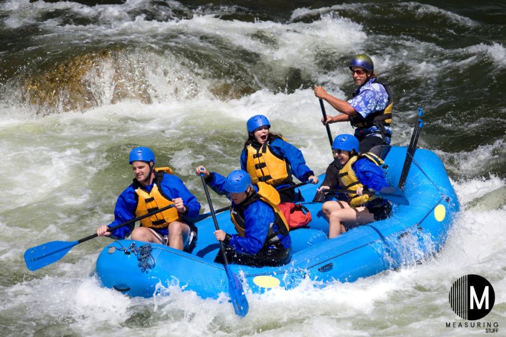 people white water rafting in strong currents