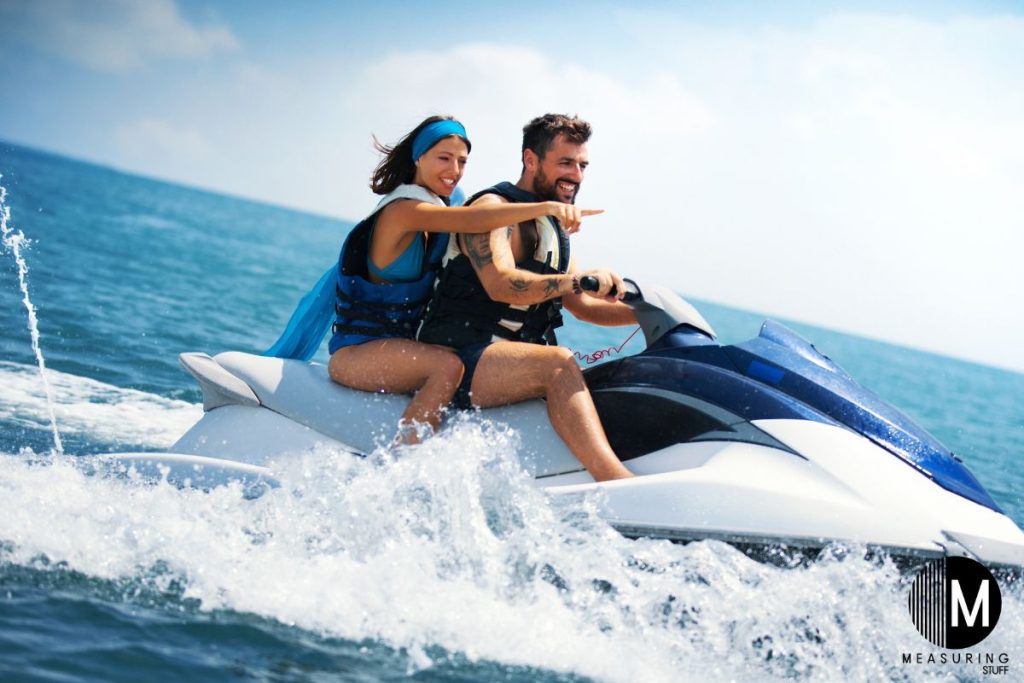 A couple riding a jet ski