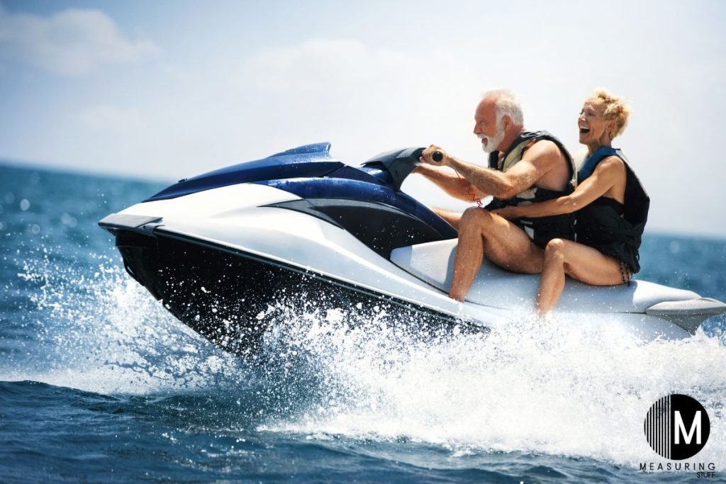 older couple riding a jet ski