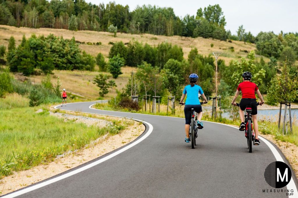 couple riding a bike on a paved path