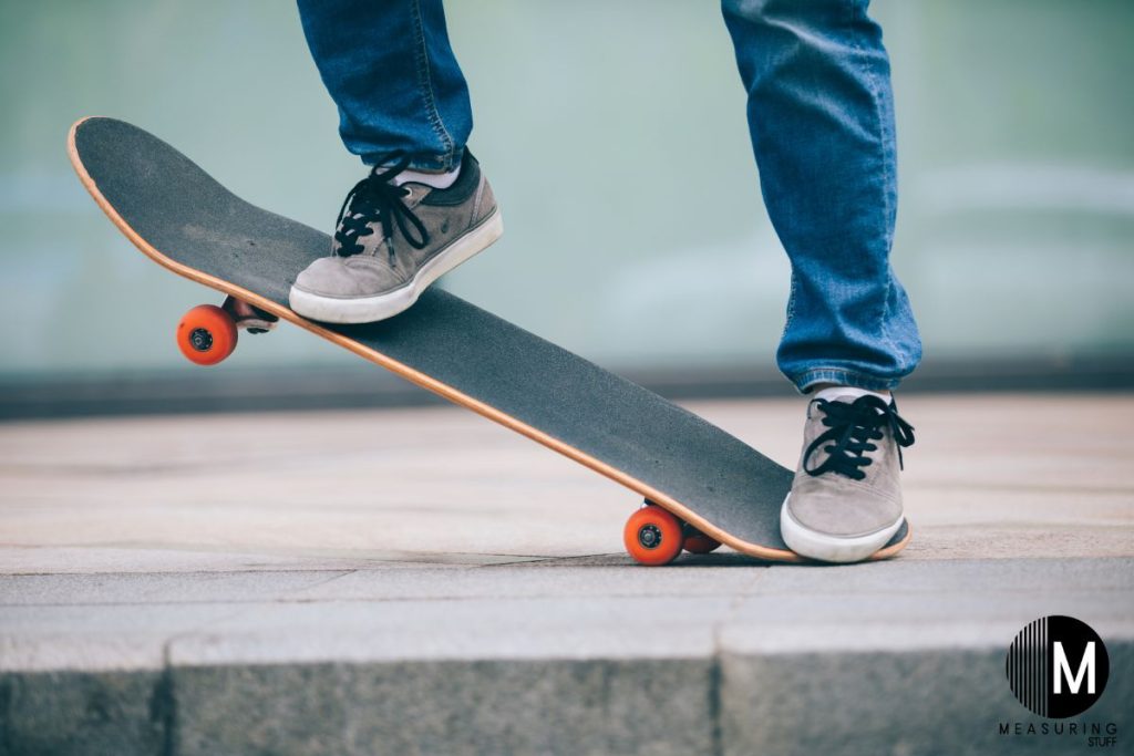 person stepping on the end of a skateboard