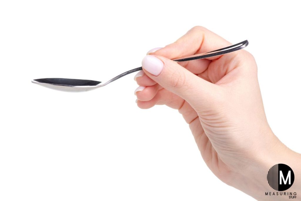 hand holding a teaspoon