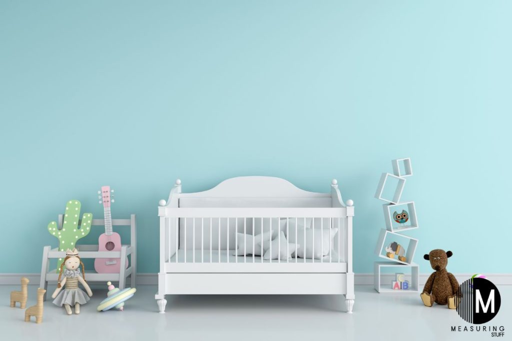 white wooden baby crib with toys 