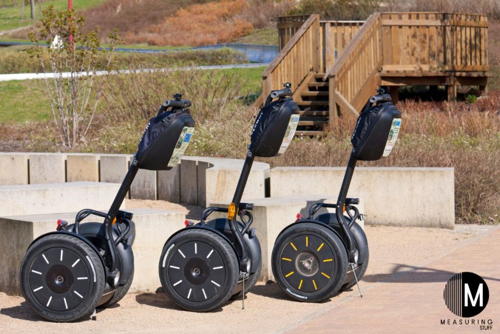 three segways parked on sidewalk