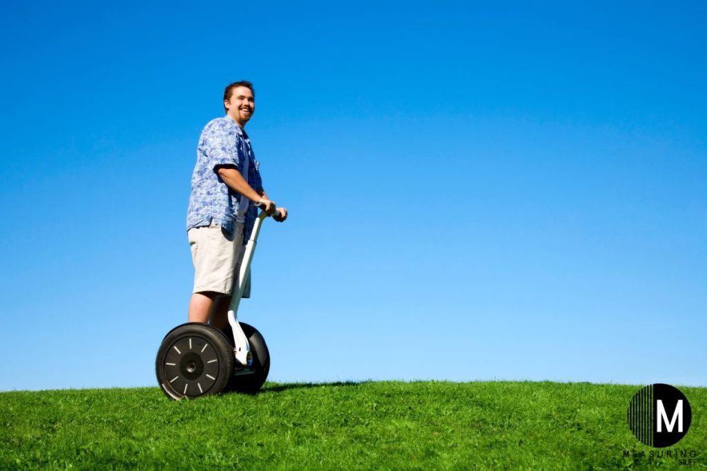 man riding a segway on grass