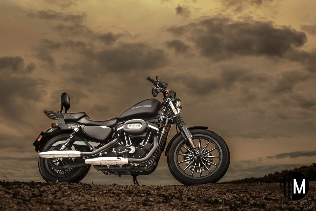motorcycle parked on gravel on a cloudy day