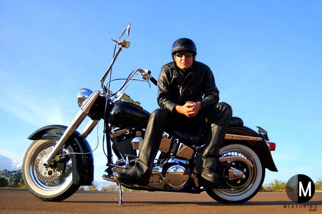 rider sitting on a motorcycle sunny day