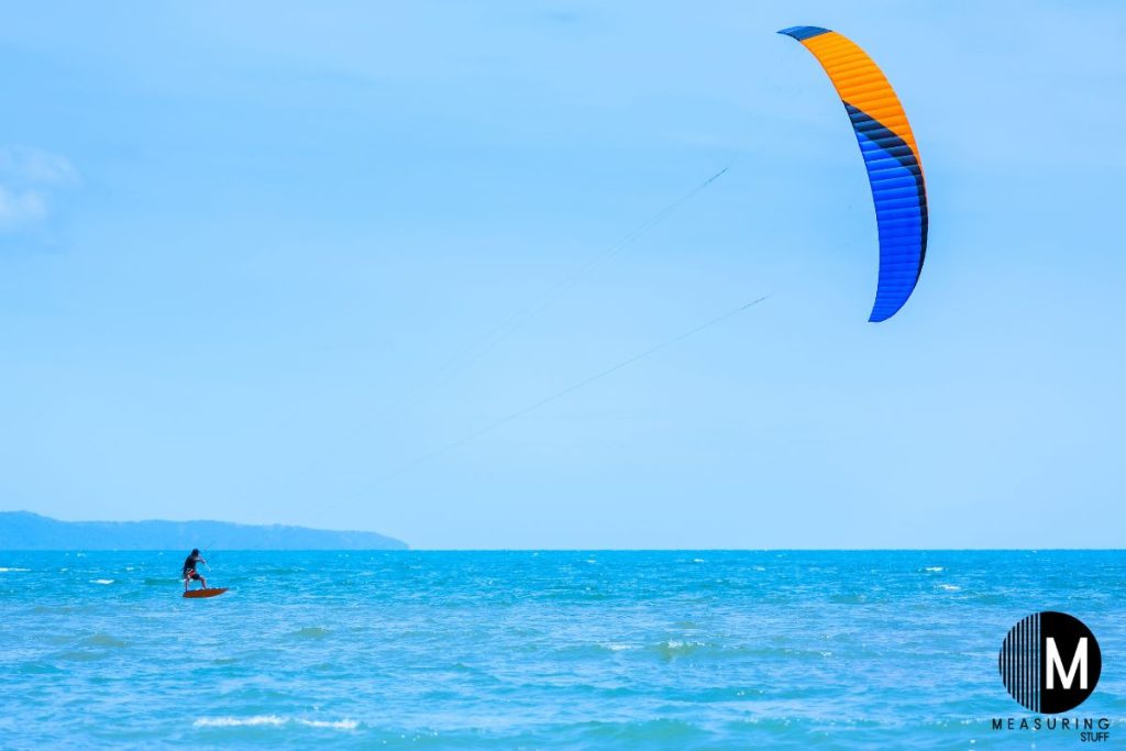 kiteboarding on ocean water on a sunny day