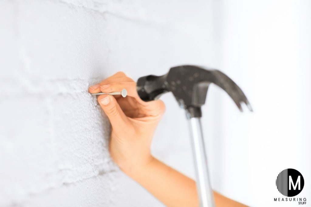 hammer a nail into drywall