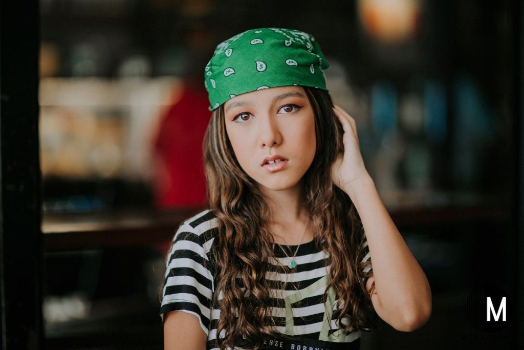 girl wearing a green bandana