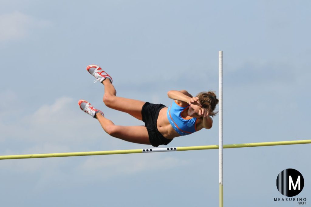 woman pole vaulting over a pole