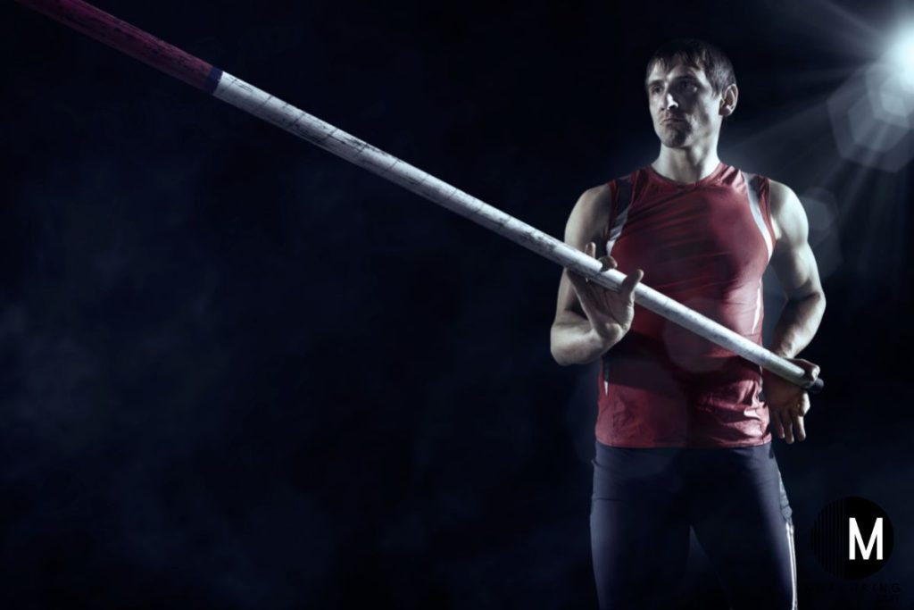 man holding a pole vault pole