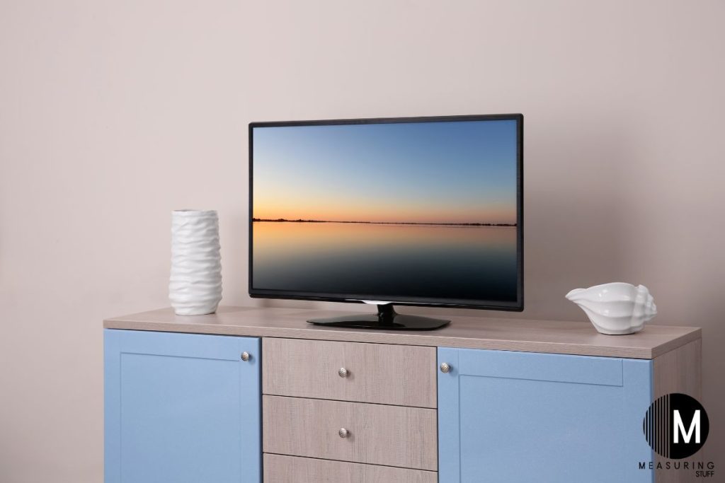 flat screen tv sitting on a dresser