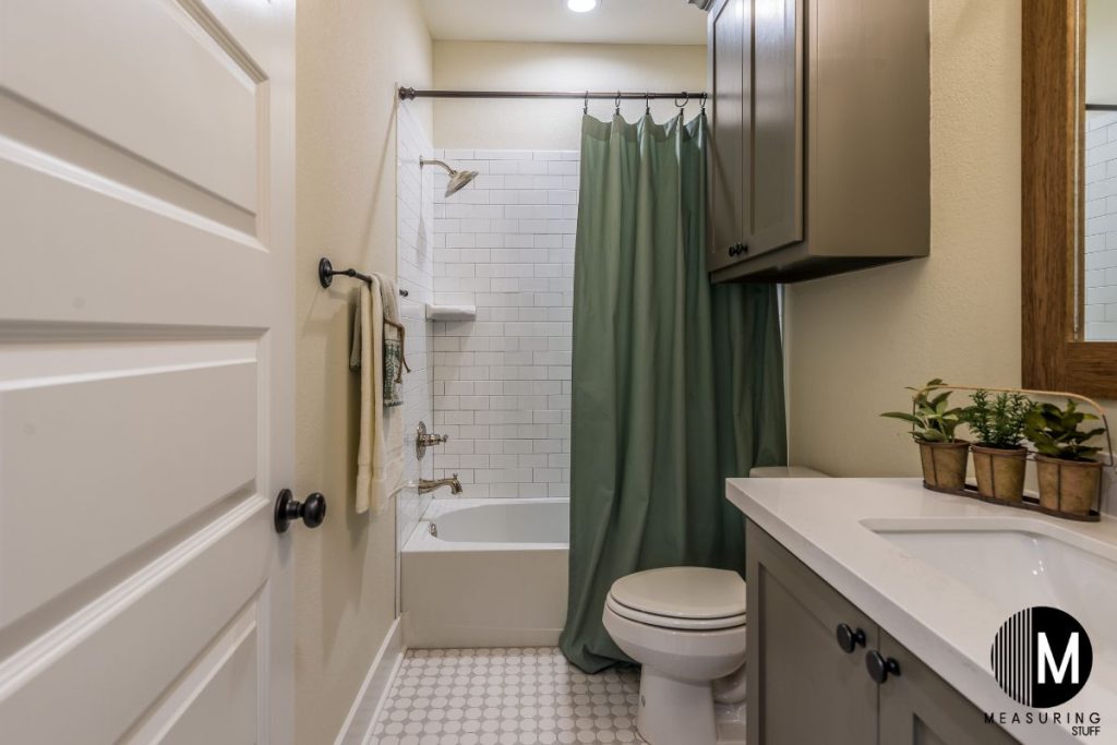 bathroom with green shower curtain
