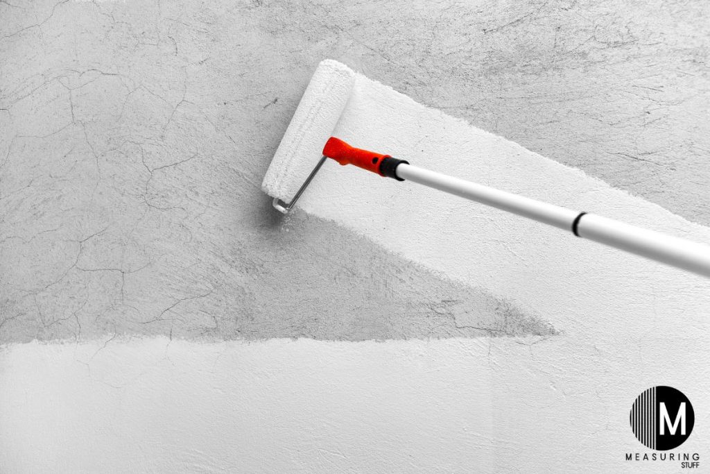 using a paint roller with white paint