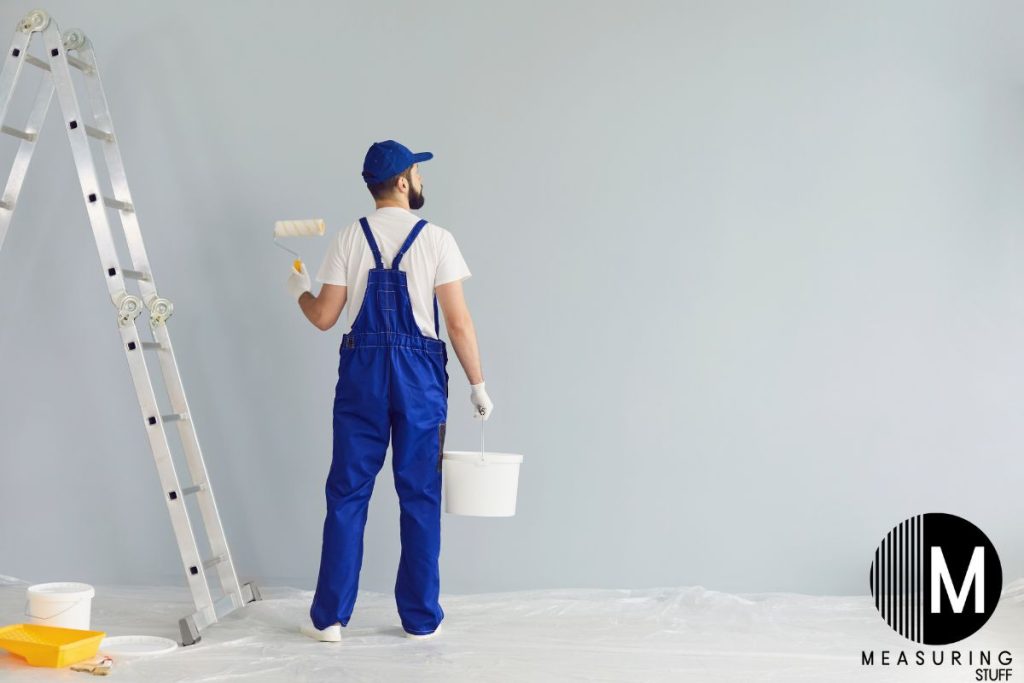 man painting a large wall