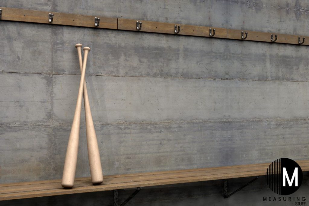 baseball bats leaning against a wall