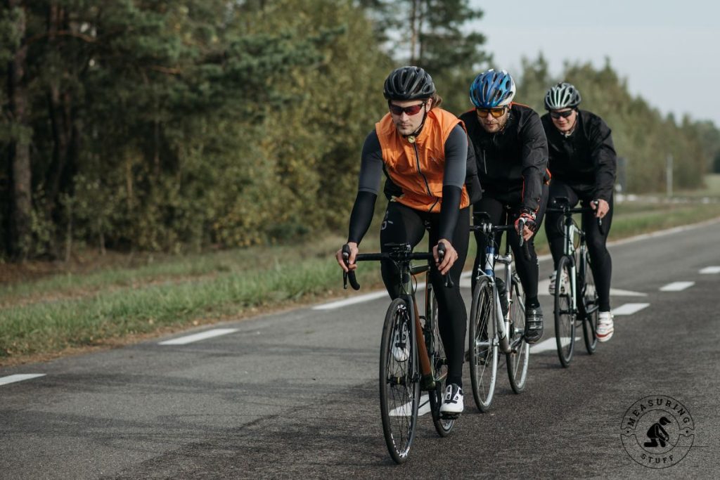 men riding racing bicycles on pavement